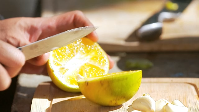 Cutting a lime on a wooden board