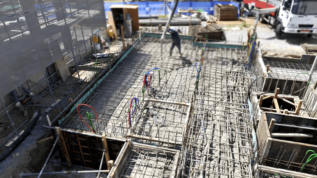 Construction worker pouring concrete