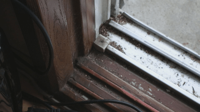 Dusty window track with dirt accumulation