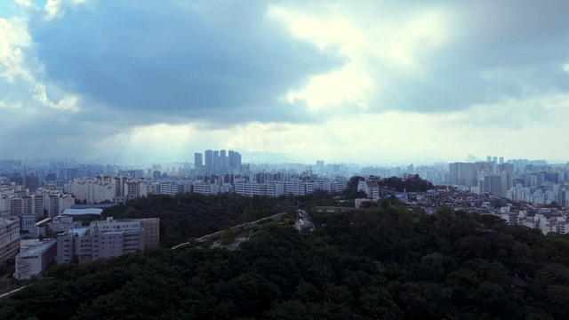 City skyline with clouds and sunlight
