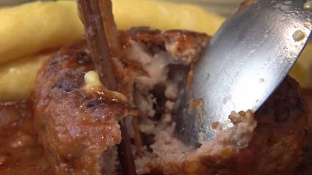 Juicy hamburger steak being sliced