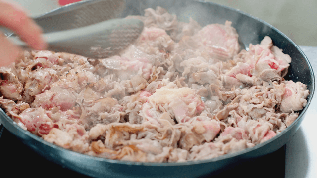 Sizzling meat cooking in a pan