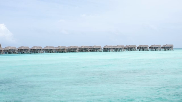 Overwater bungalows on a clear ocean