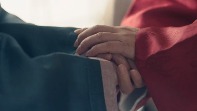 Traditional Korean attire with hands
