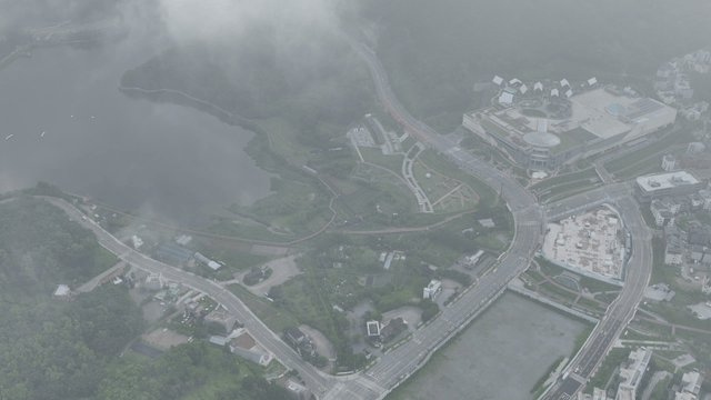 Aerial view of a city with roads and greenery