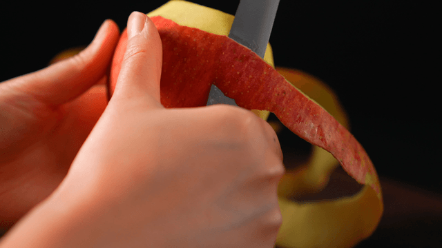 Peeling an apple with a knife