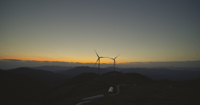 Sunrise and wind turbines on the mountain