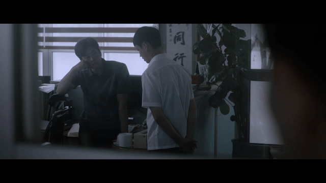Serious student and teacher talking in dark teachers’ office