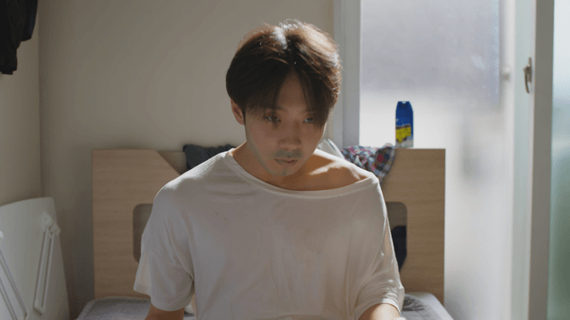 Man waking up in a sunlit room