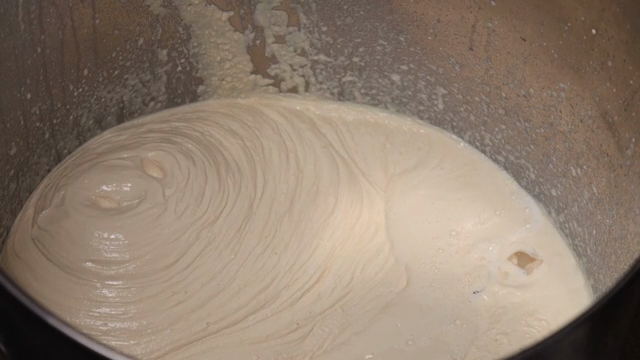 Soybean soup falling into a large bowl