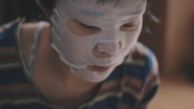 Woman answering a call after removing a face mask