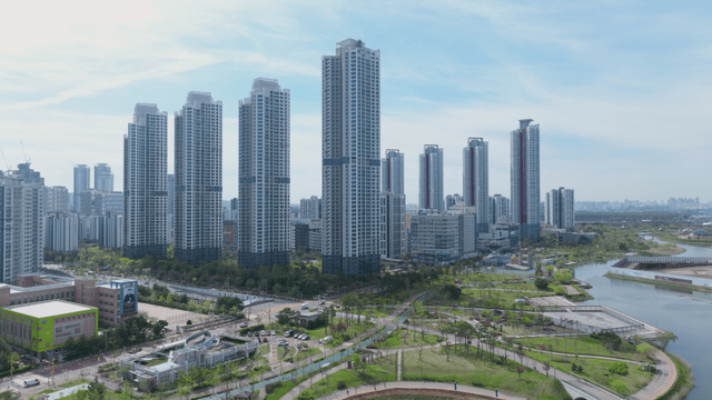 Modern city skyline with lake park and tall buildings