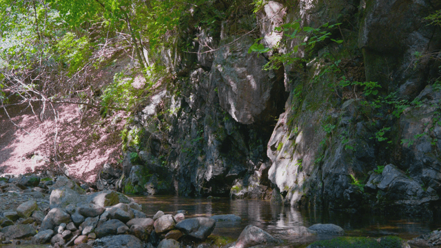 Calm stream flowing through rocky terrain