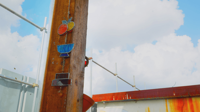 Stained glass on a wooden pillar under clear sky