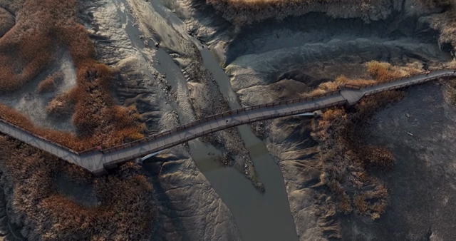Wooden bridge over a winding river