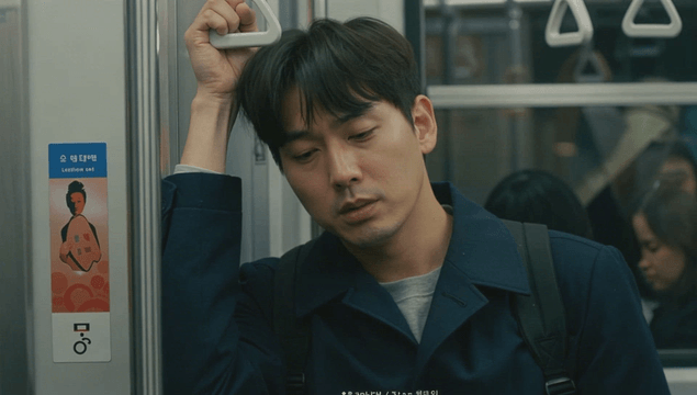 Man sleeping while holding a subway strap