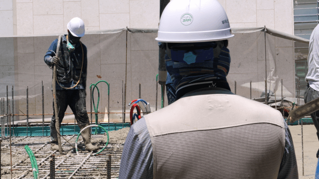 Construction workers pouring concrete