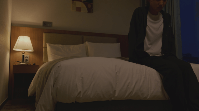 Woman lying on a bed in a dark room