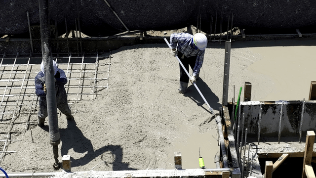 Construction workers pouring concrete
