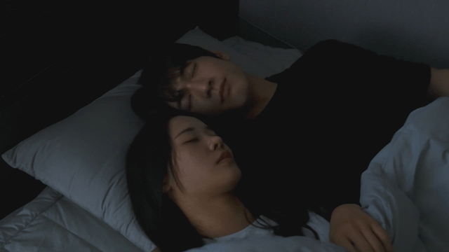 Couple sleeping peacefully in bed