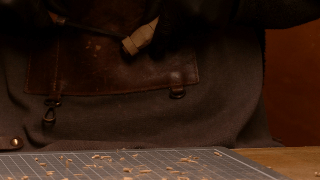 Craftsman carving wood precisely with a knife