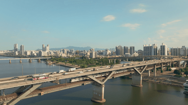 A bustling city with a bridge over a river