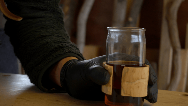 Hot teacup with wooden sleeve