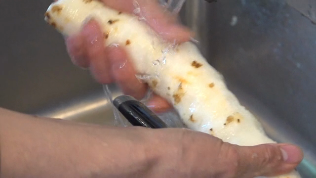 Peeled yam being rinsed in water