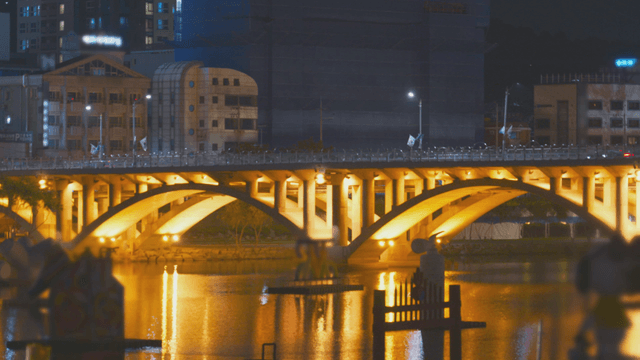 Glowing bridge road over a nocturnal river
