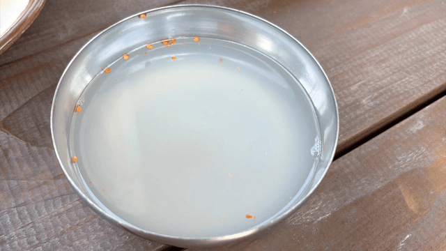 Clear dongchimi broth in a stainless bowl