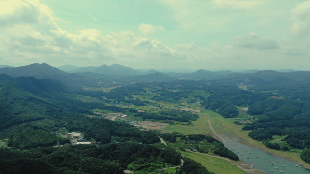 A vast landscape with mountains and fields