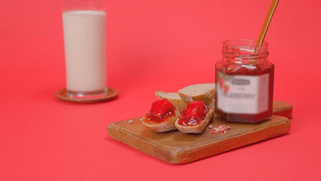 Glass of milk and strawberry jam toast