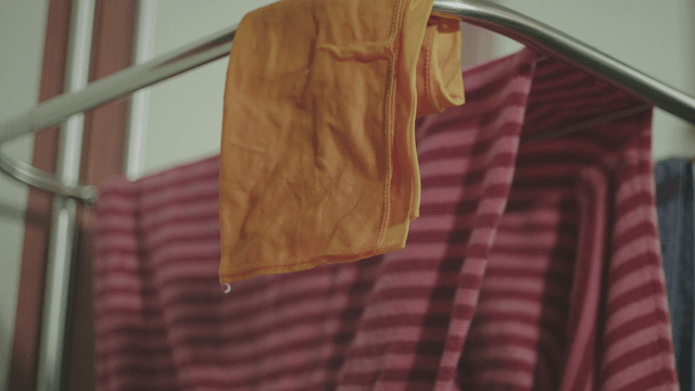 Towel dripping water hanging on a drying rack