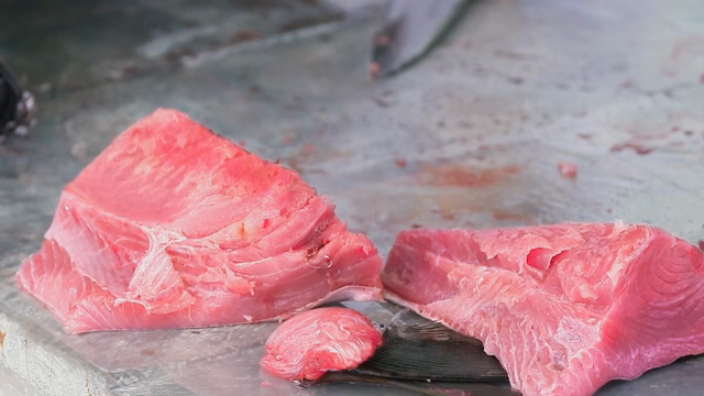 Freshly cut pieces of raw tuna on a table