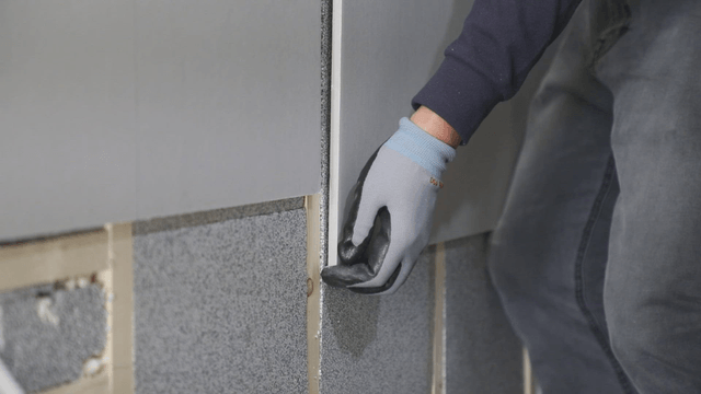 Worker installing insulation panels