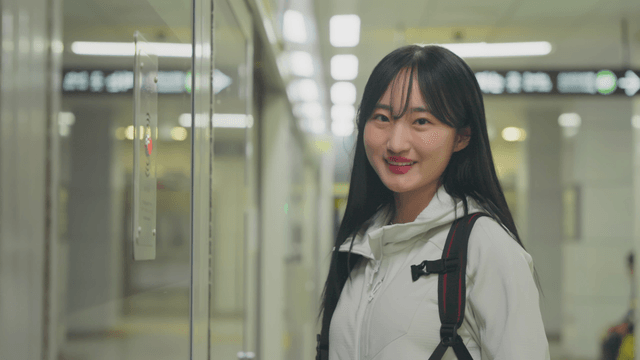 Smiling woman waiting on subway platform