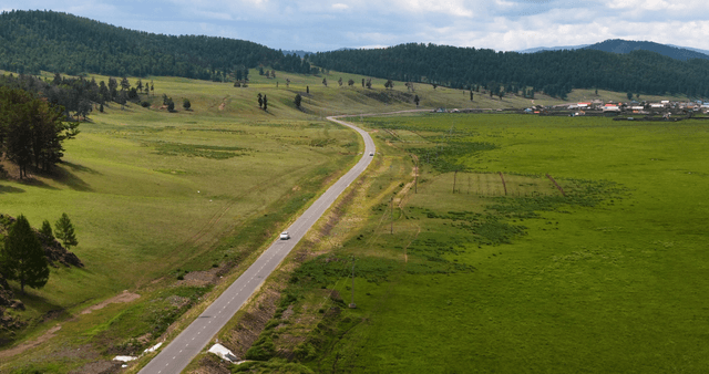 A winding road through lush green fields