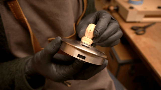 Artisan assembling wooden pieces with metal parts