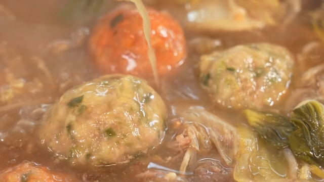 A pot of Korean hot pot with dumplings