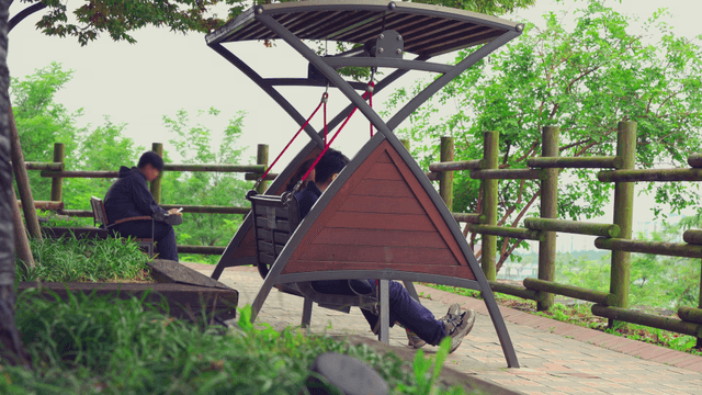 Couple relaxing on a swing in the park