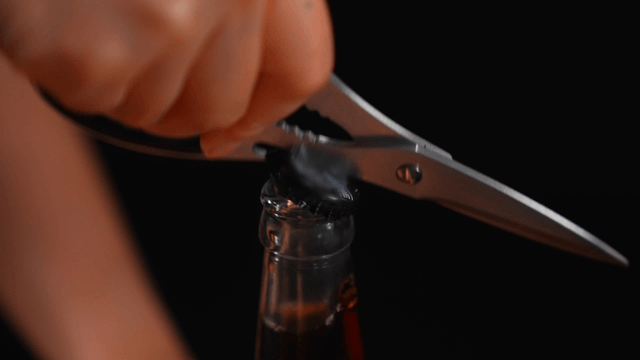 Opening a bottle with scissors