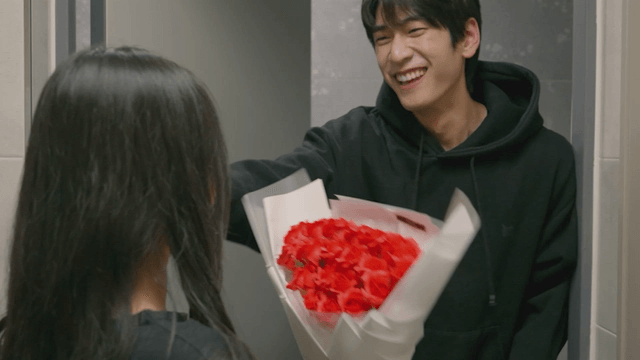 Couple exchanging flowers at the entrance