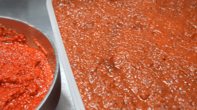Fermented red seasoning in large container