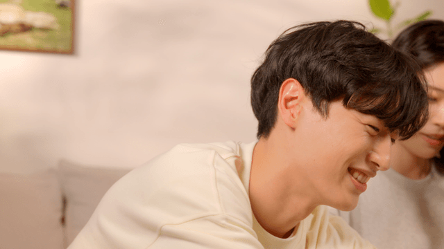 Couple organizing clothes in cozy living room