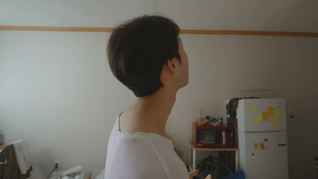 Man looking up in a cluttered room