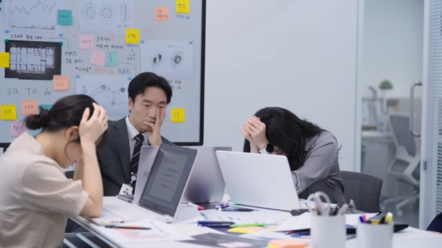 A team in despair after hearing about a lost deal over the phone