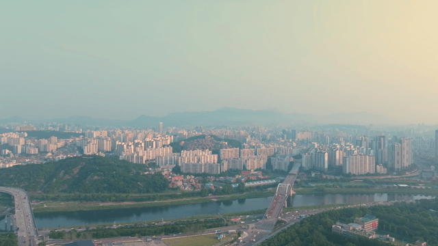 Sprawling cityscape with a river and bridge