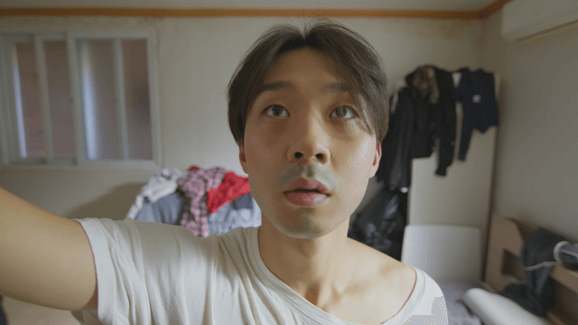 Man catching a bug in a messy room
