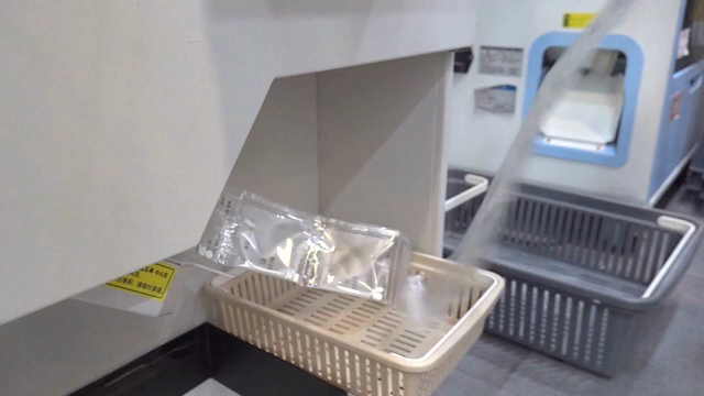 Medicine packets being dispensed into a basket