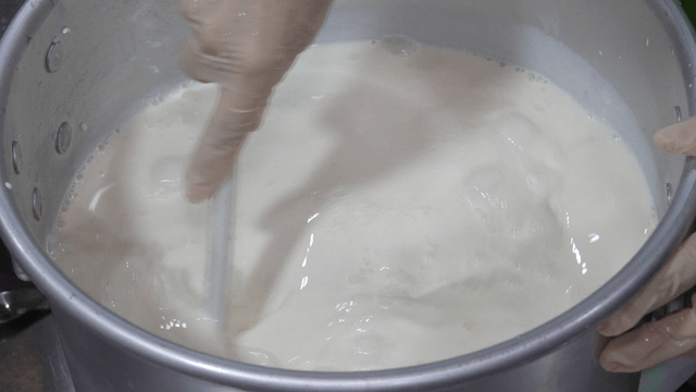 Stirring milk in a large pot